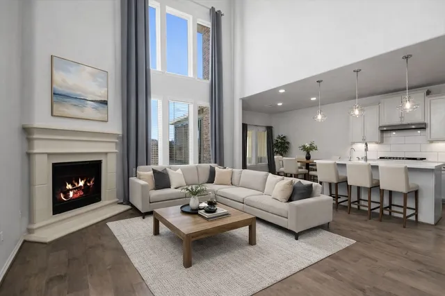 a kitchen with stainless steel appliances kitchen island granite countertop a dining table chairs and white cabinets