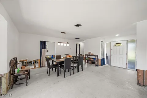 a view of a dining room with furniture and chandelier