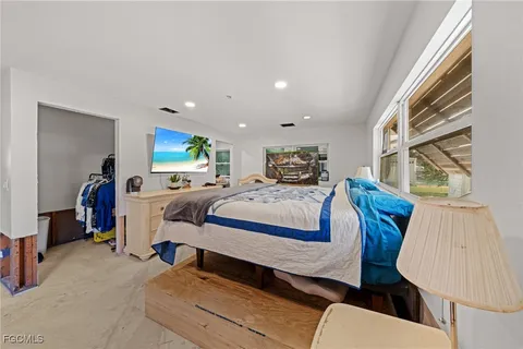 a bedroom with furniture and a window