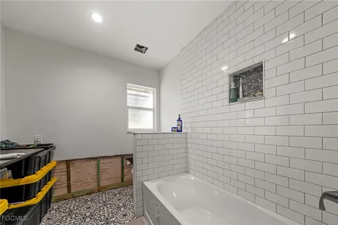 a bathroom with a bathtub and a sink