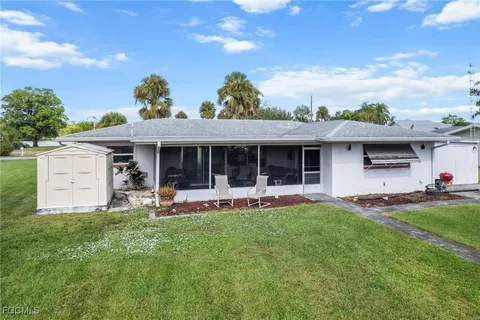 a front view of house with a garden and patio