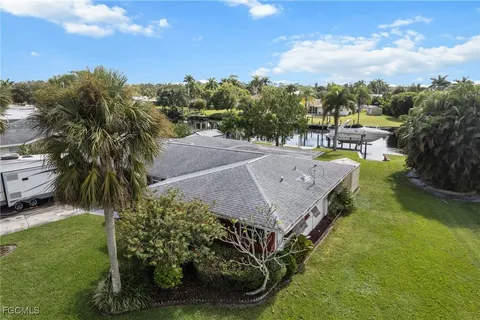 a view of a house with a yard and sitting area