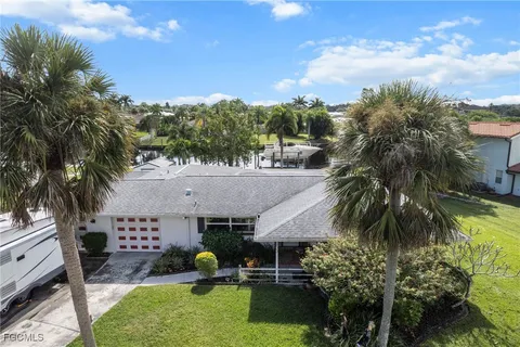 a swimming pool with outdoor seating and barbeque oven