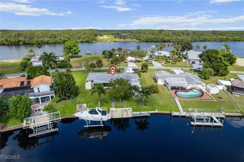 an aerial view of residential houses with outdoor space and lake view