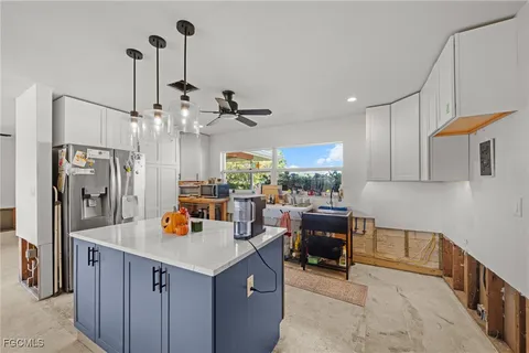 a kitchen with a refrigerator a oven and a sink