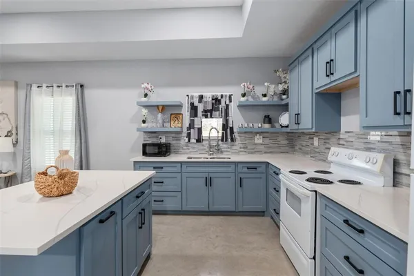 a kitchen with stainless steel appliances granite countertop a sink dishwasher stove and cabinets