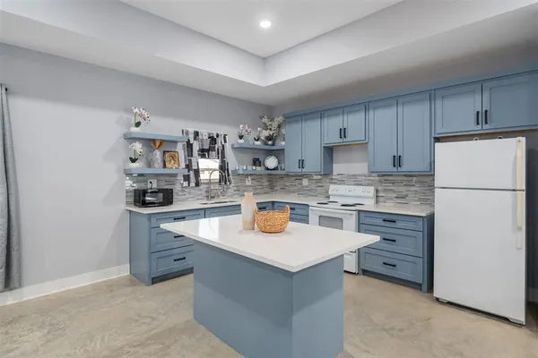 a kitchen with stainless steel appliances granite countertop a refrigerator and a stove
