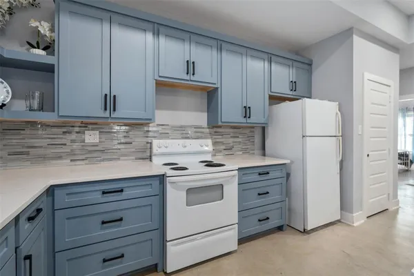 a kitchen with cabinets appliances and a sink