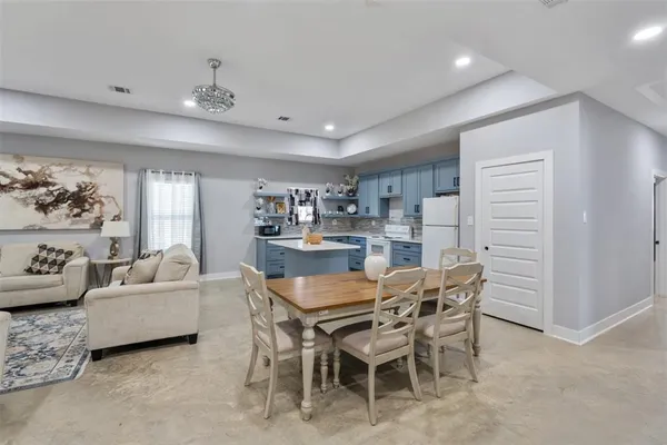 a view of a dining room with furniture and chandelier