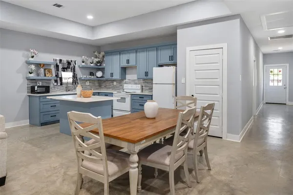 a dining room with furniture and wooden floor