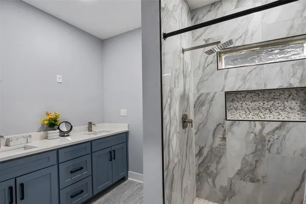 a bathroom with a double vanity sink and mirror