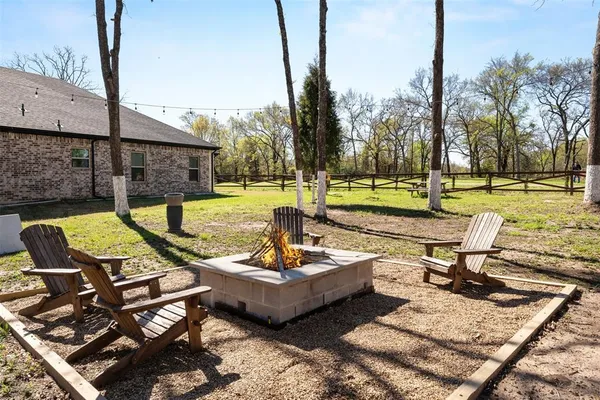 a view of a swimming pool with lounge chairs in patio