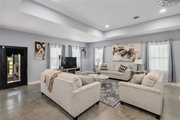 a living room with furniture and a flat screen tv
