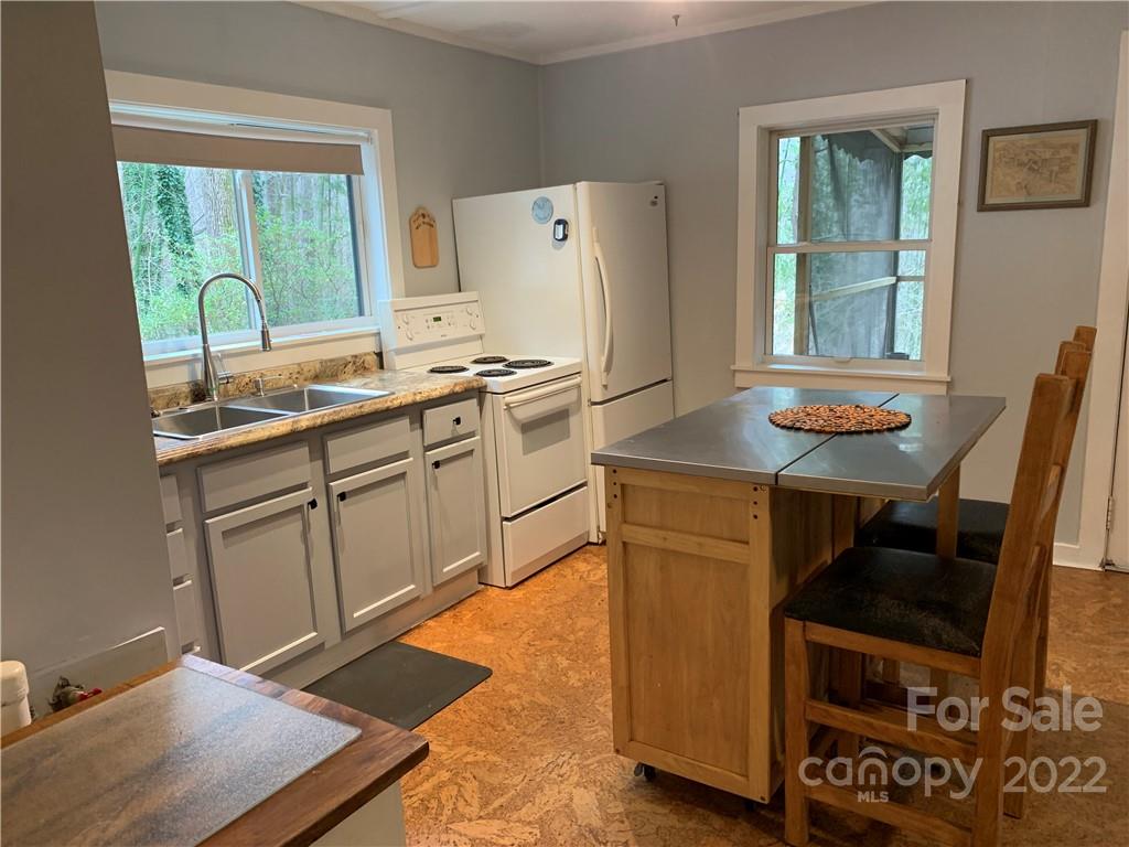 445 Autumn Lane Tryon, NC 28782 - Photo 14 of 27 a kitchen with stainless steel appliances a stove a sink and a refrigerator