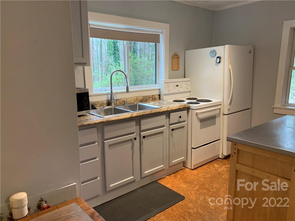 445 Autumn Lane Tryon, NC 28782 - Photo 15 of 27 a kitchen with stainless steel appliances granite countertop a sink stove and refrigerator