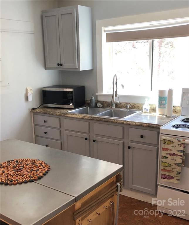 445 Autumn Lane Tryon, NC 28782 - Photo 16 of 27 a kitchen with cabinets appliances and a window