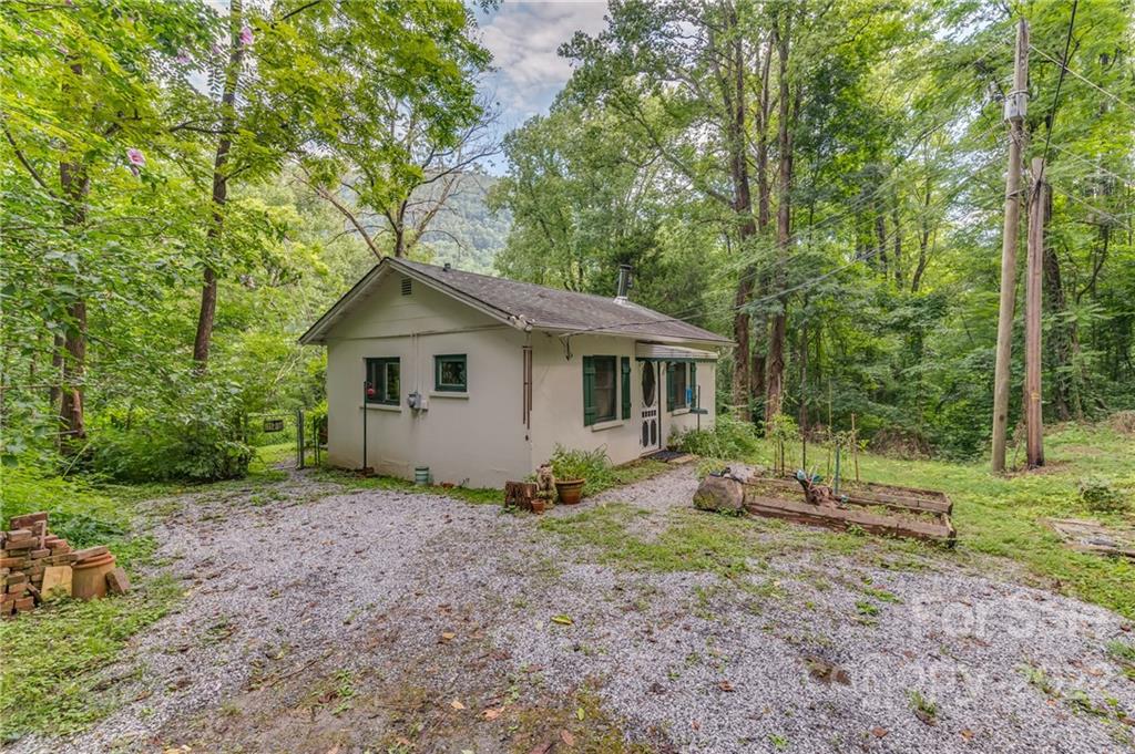 445 Autumn Lane Tryon, NC 28782 - Photo 2 of 27 a view of a house with backyard and trees