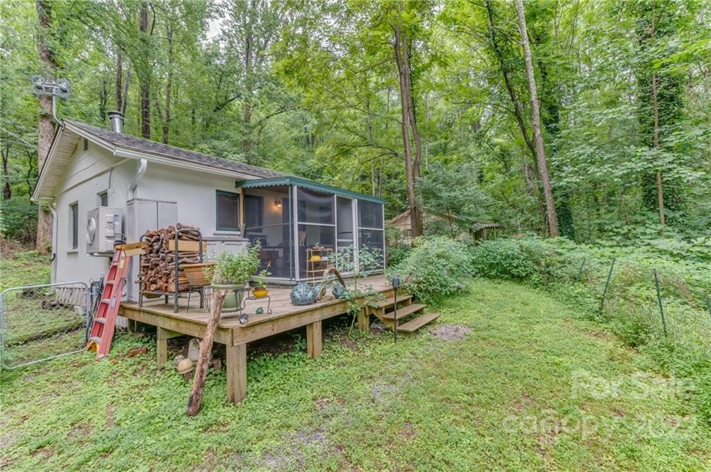 445 Autumn Lane Tryon, NC 28782 - Photo 8 of 27 a backyard of a house with table and chairs