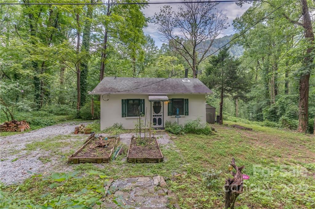 445 Autumn Lane Tryon, NC 28782 - Photo 9 of 27 a front view of a house with garden