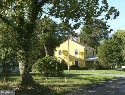 7041 Thorneton Road St. Michaels, MD 21663 - Photo 1 of 19 a front view of a house with a yard and a garden