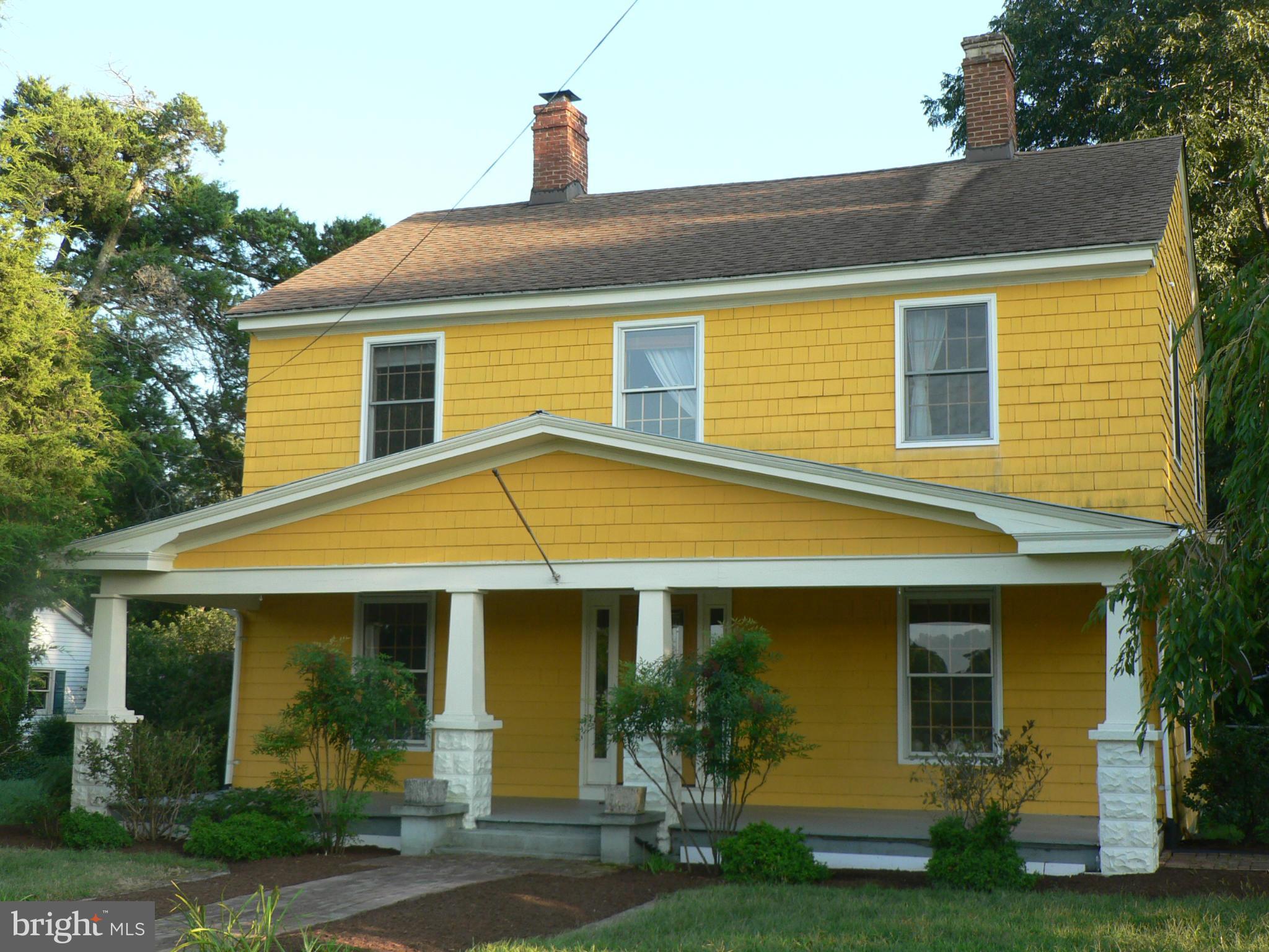 7041 Thorneton Road St. Michaels, MD 21663 - Photo 3 of 19 a view of a white house with potted plants and a large tree
