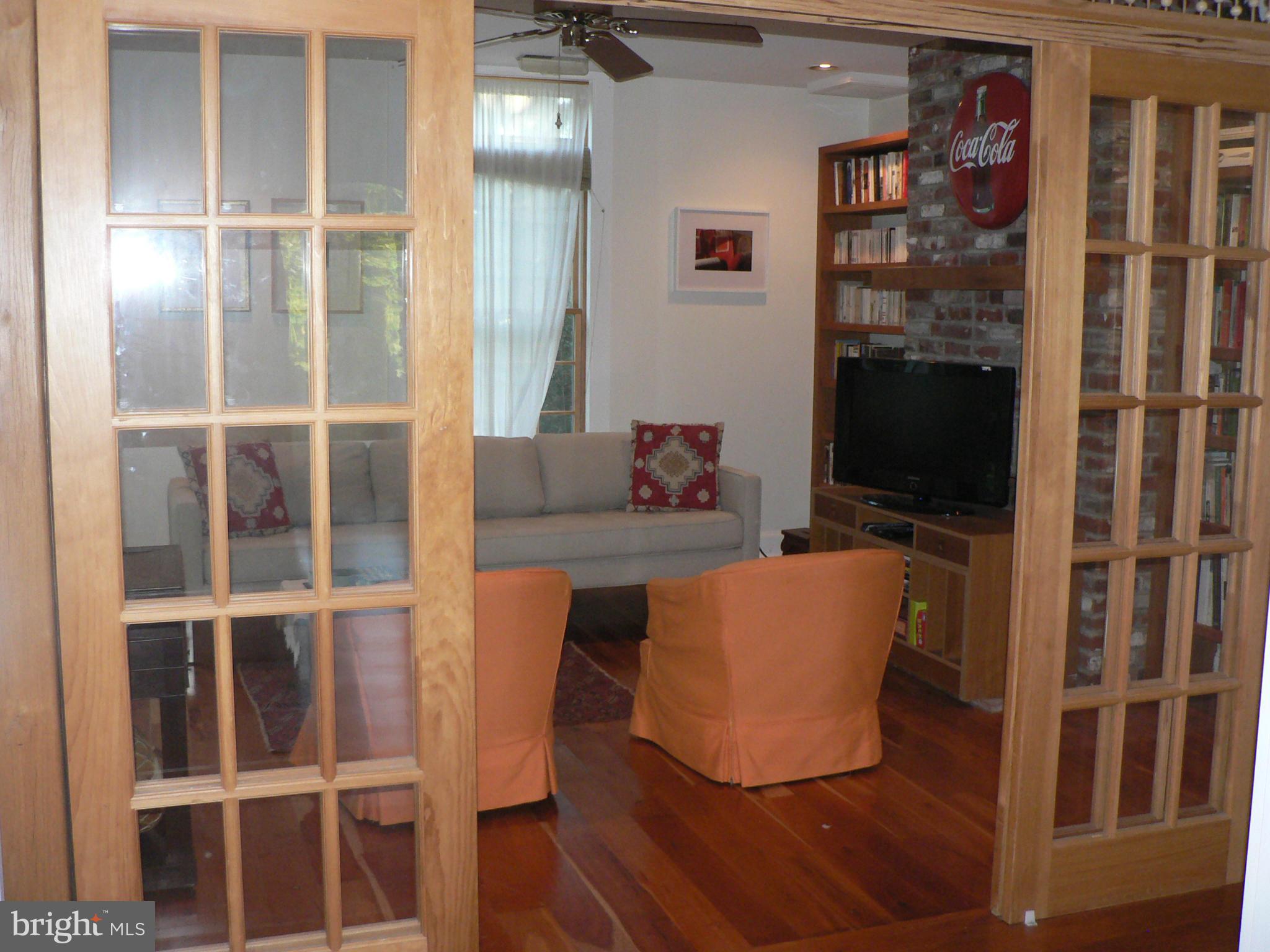 7041 Thorneton Road St. Michaels, MD 21663 - Photo 7 of 19 a living room with furniture windows and a flat screen tv