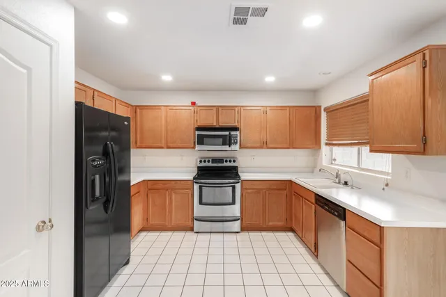 a kitchen with stainless steel appliances a stove sink and microwave