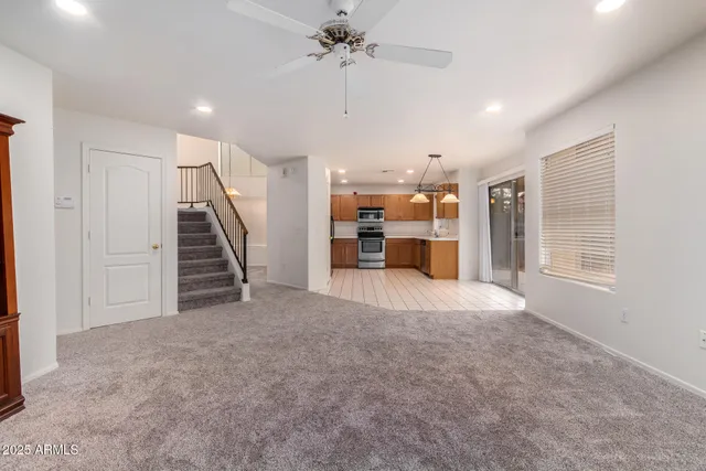 an empty room with fan and entrance