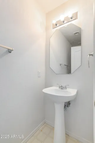 an empty room with a window and a dresser