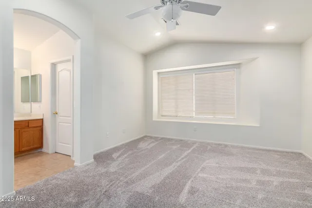 a spacious bathroom with a tub sink and mirror