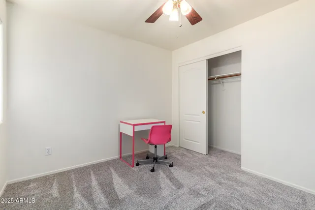 a view of a house with a wooden fence