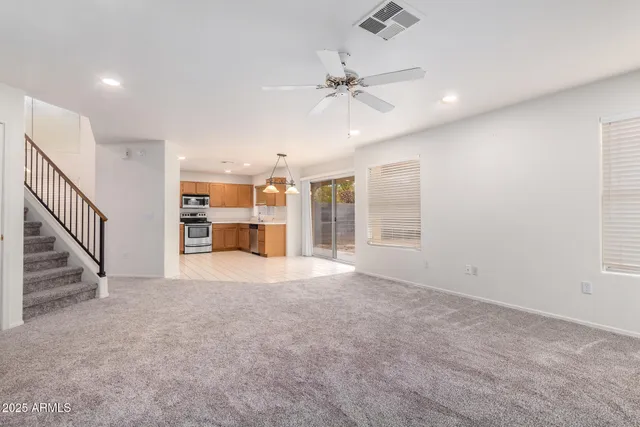 an empty room with windows and cabinet