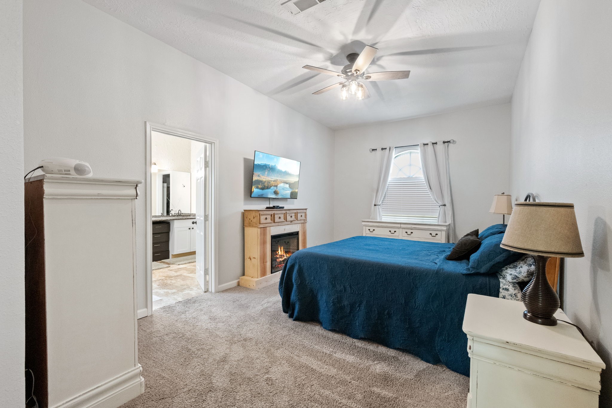 5809 Cajun Way Baytown, TX 77523 - Photo 12 of 29 a bedroom with a bed and a chandelier