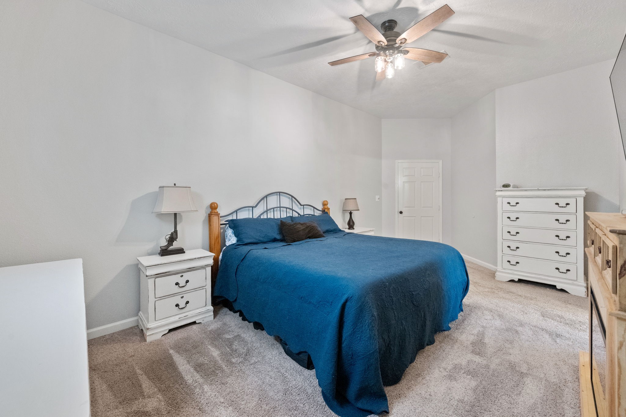 5809 Cajun Way Baytown, TX 77523 - Photo 13 of 29 a bedroom with a bed and a chandelier