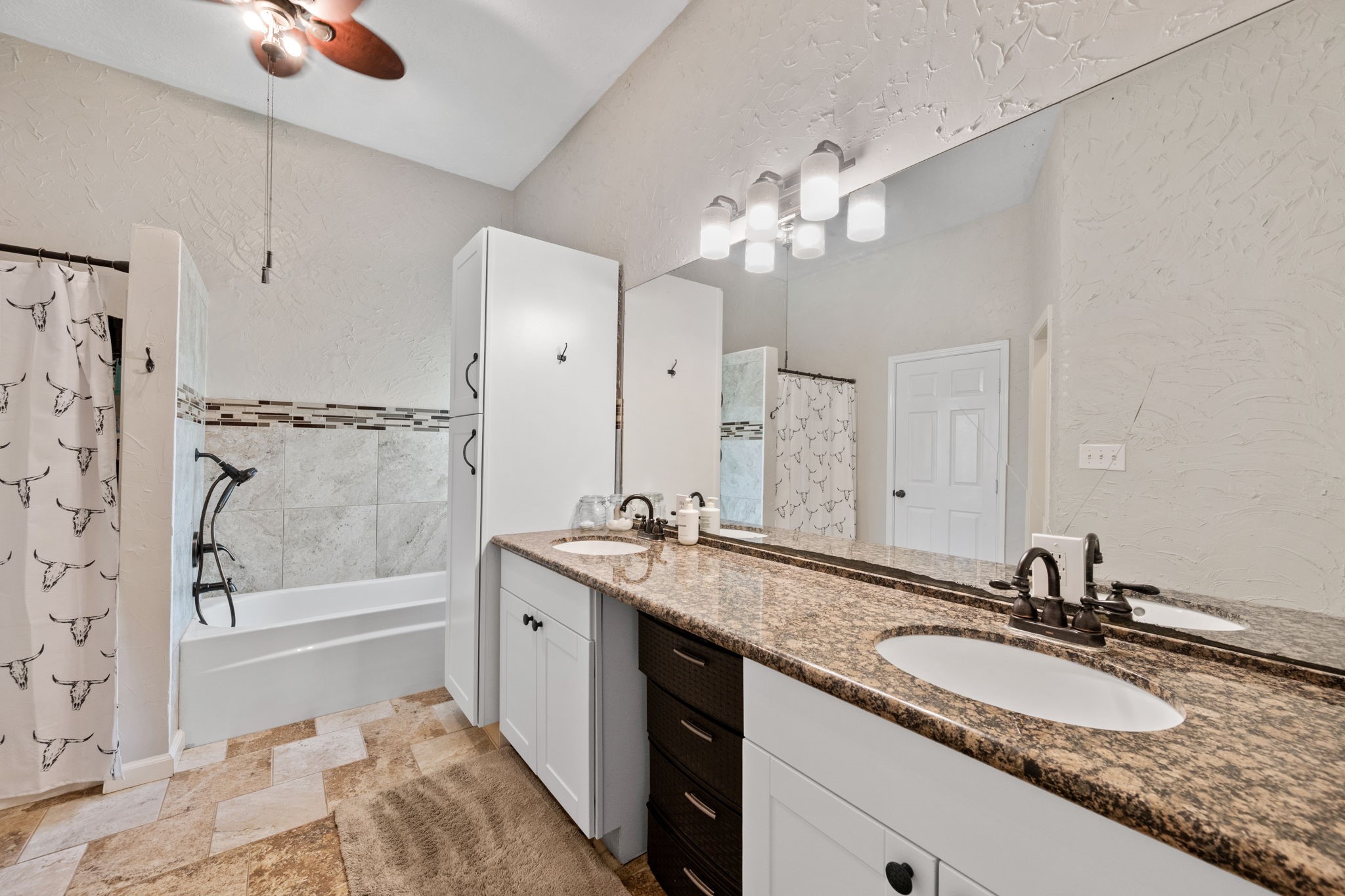 5809 Cajun Way Baytown, TX 77523 - Photo 14 of 29 a bathroom with a granite countertop double vanity sink a mirror and a bathtub