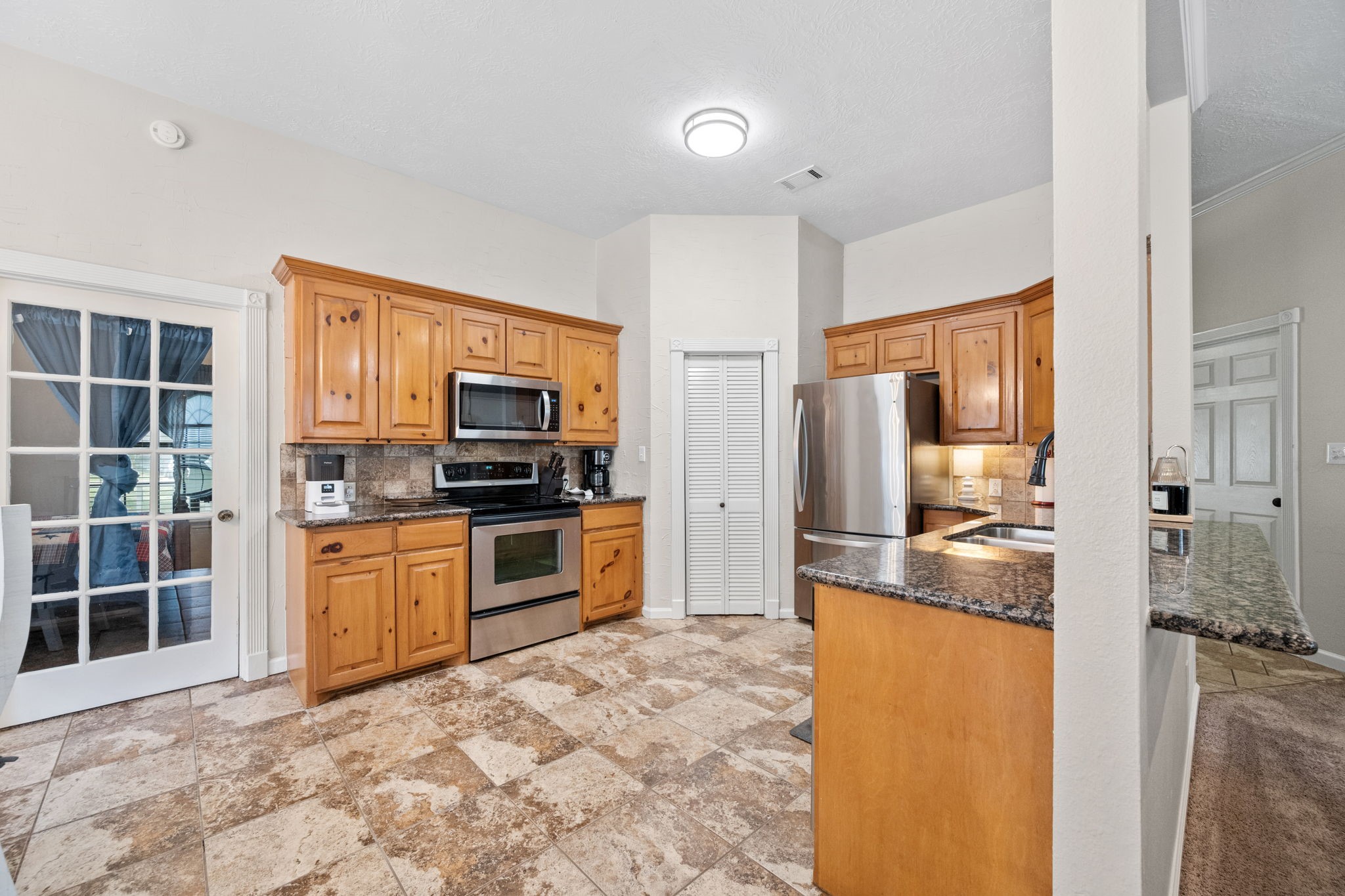 5809 Cajun Way Baytown, TX 77523 - Photo 8 of 29 a kitchen with stainless steel appliances granite countertop a stove refrigerator and microwave