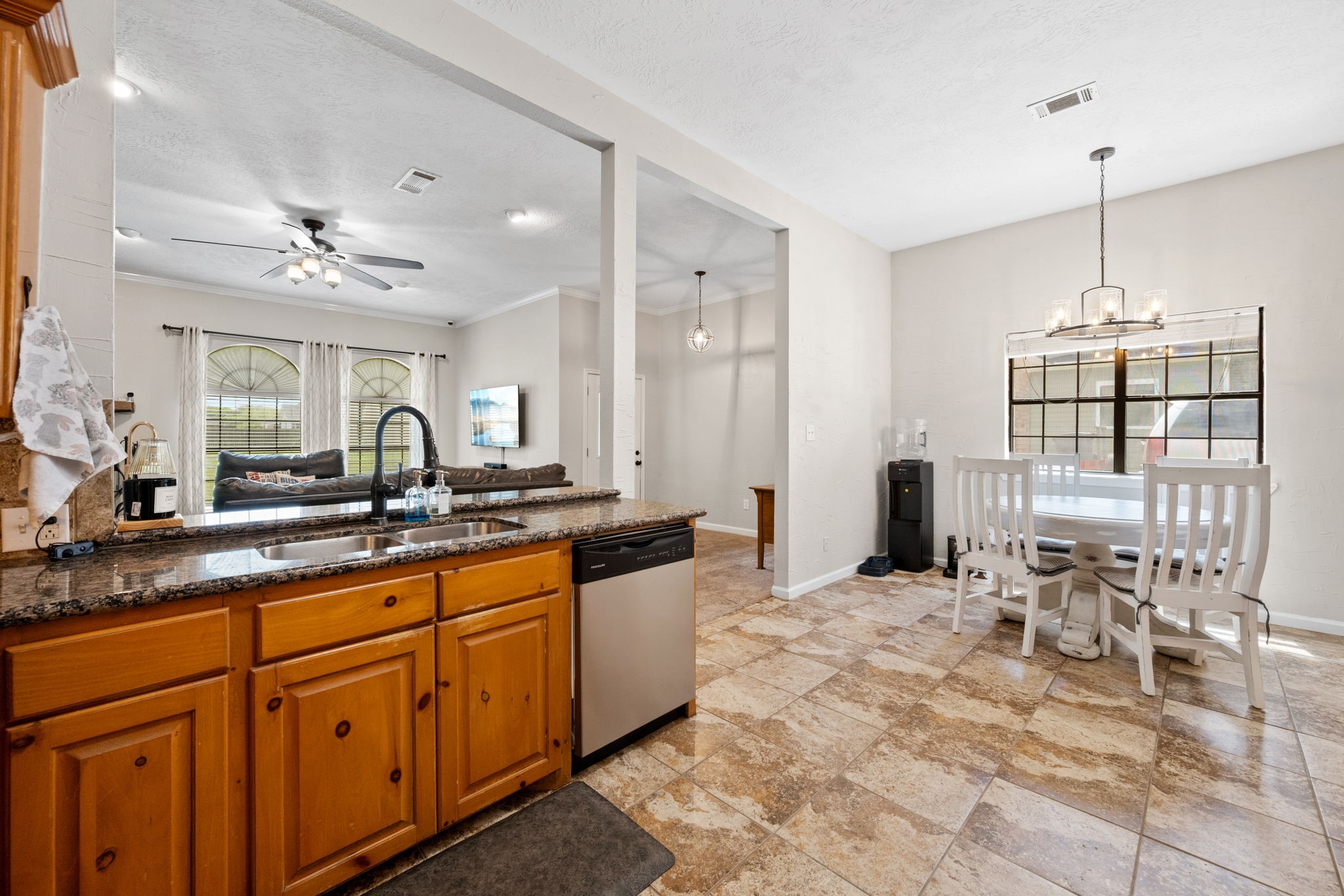 5809 Cajun Way Baytown, TX 77523 - Photo 10 of 29 a large kitchen with kitchen island stainless steel appliances a stove sink table and chairs