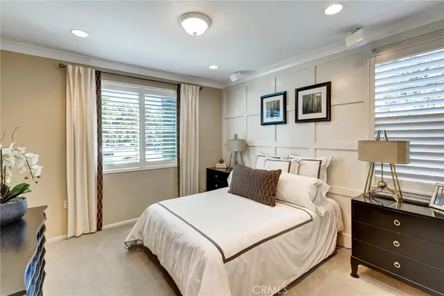 a bedroom with a bed and a night stand