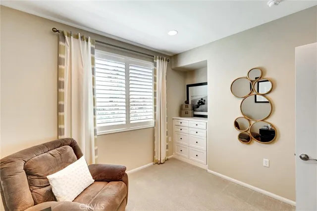 a living room with furniture and a mirror
