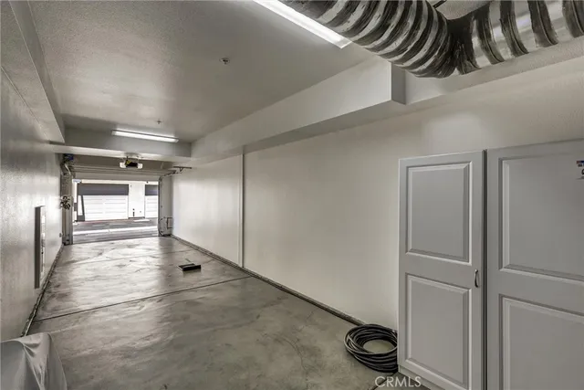 a dinning room with stainless steel appliances kitchen island granite countertop a dining table chairs and a refrigerator