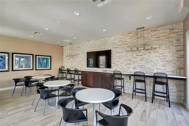 a living room with fireplace furniture and a large window