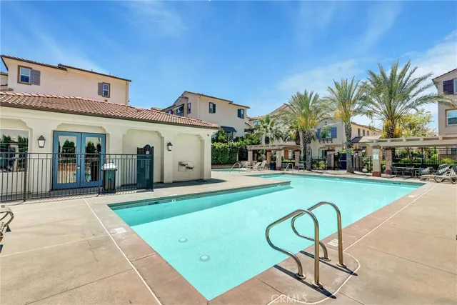 a view of a house with swimming pool and sitting area