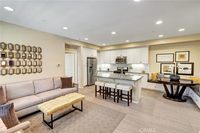 a living room with furniture a window and kitchen view