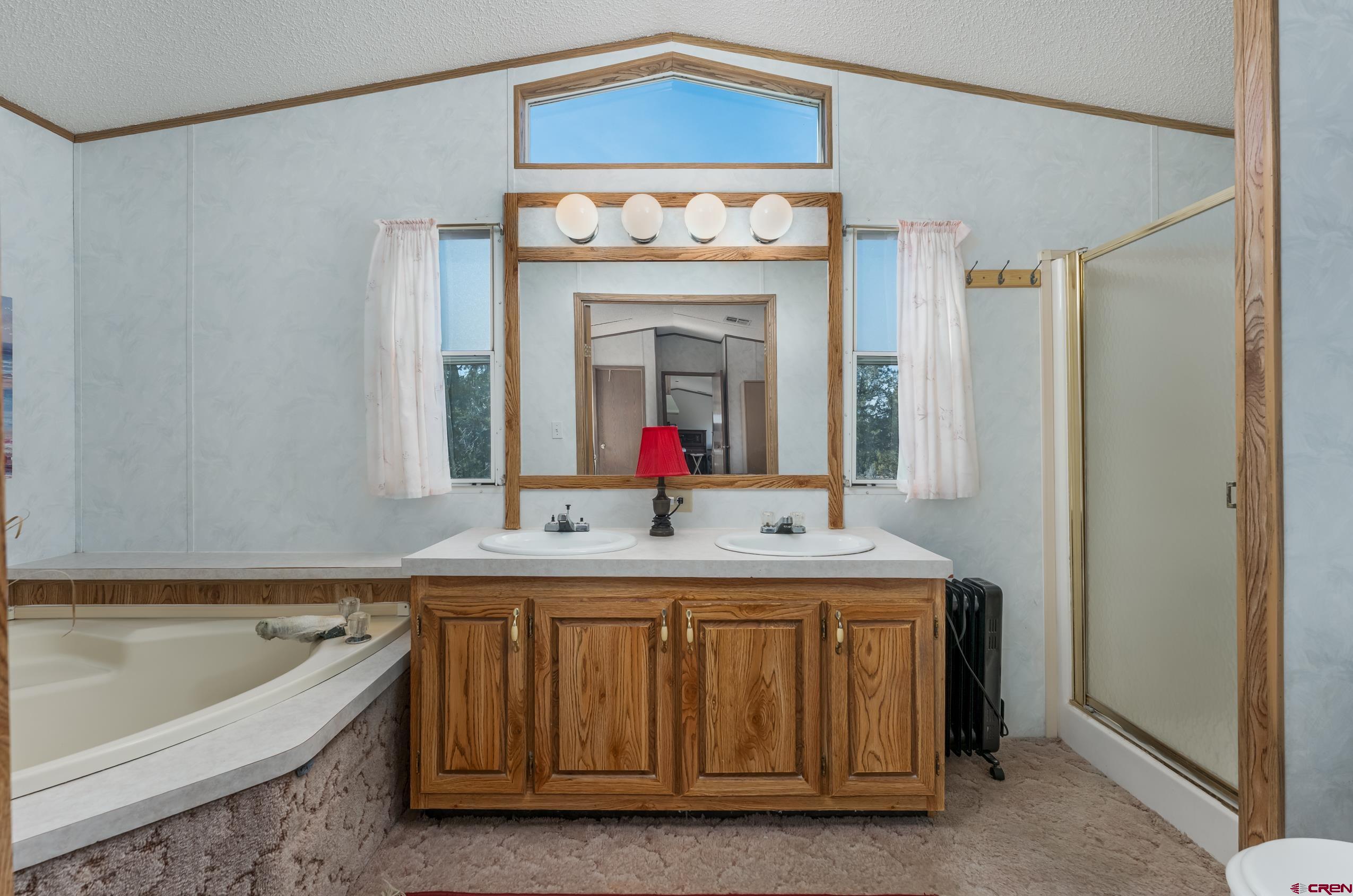 1837 Anna Road Ignacio, CO 81137 - Photo 12 of 32 a bathroom with a tub sink and mirror