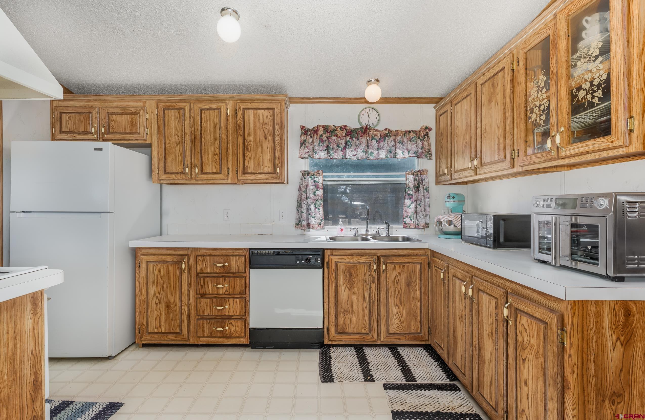 1837 Anna Road Ignacio, CO 81137 - Photo 18 of 32 a kitchen with stainless steel appliances a stove a sink and a refrigerator