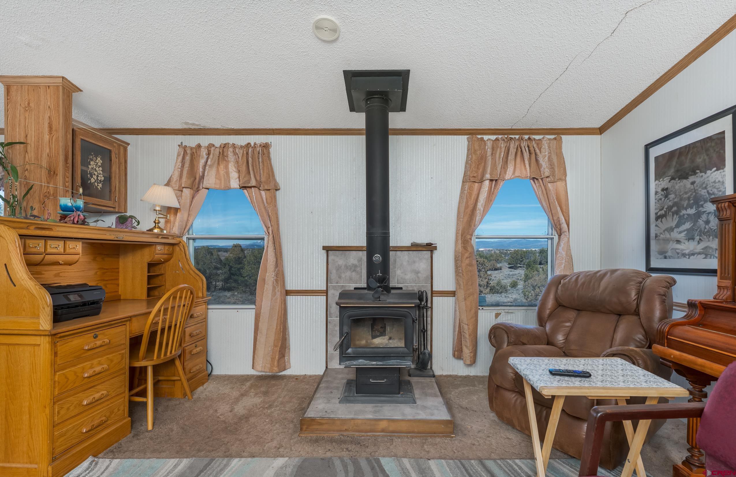 1837 Anna Road Ignacio, CO 81137 - Photo 23 of 32 a living room with furniture a fireplace and a table