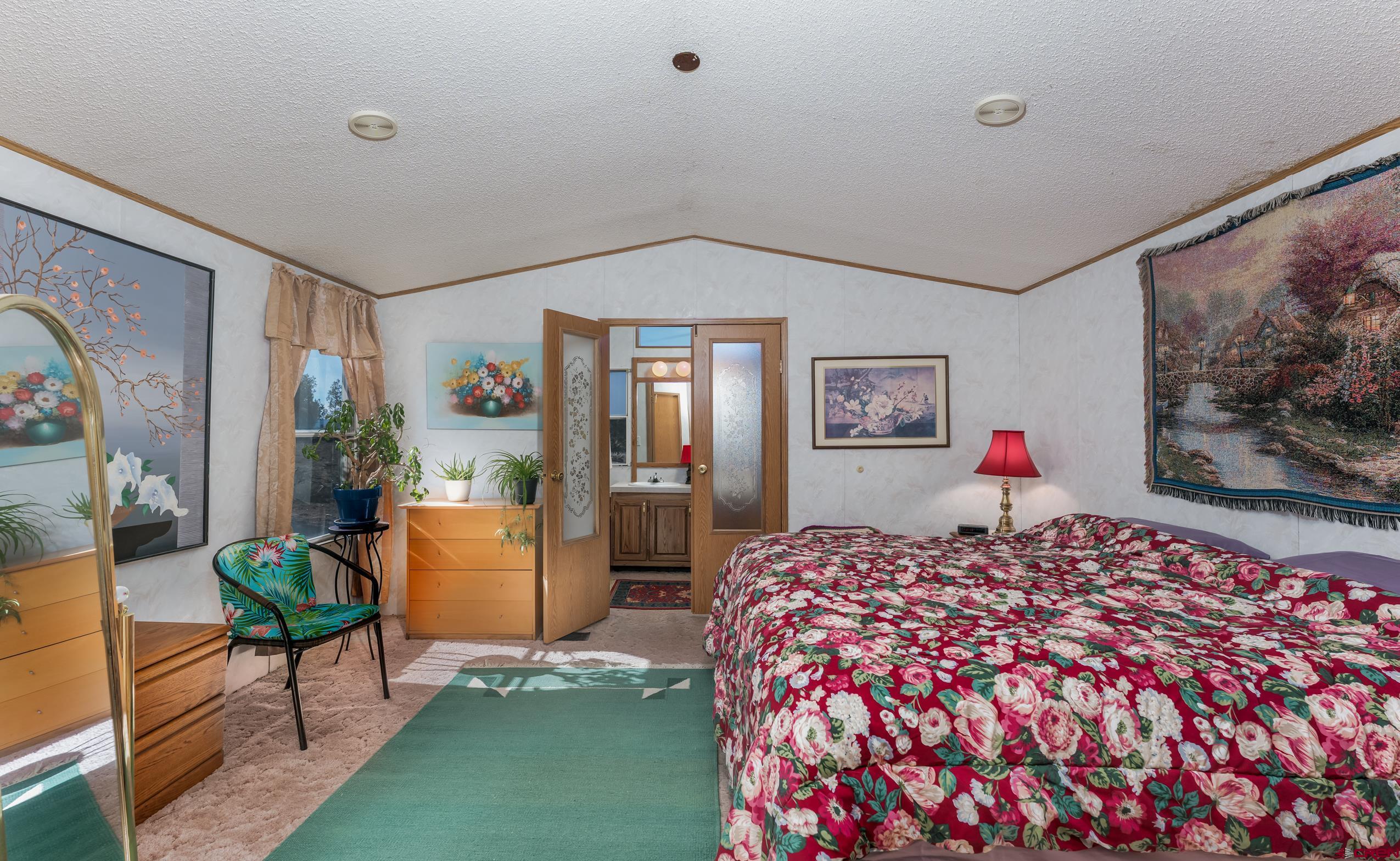 1837 Anna Road Ignacio, CO 81137 - Photo 8 of 32 a bedroom with a bed and a painting on the wall