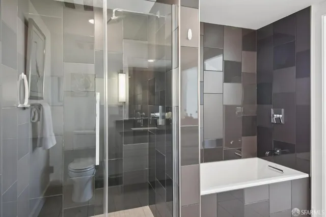 a bedroom with a bed a mirror and a window