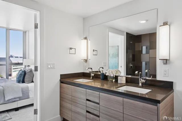 a bathroom with a sink mirror and toilet