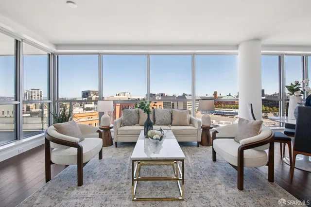 a living room with furniture large window and rug